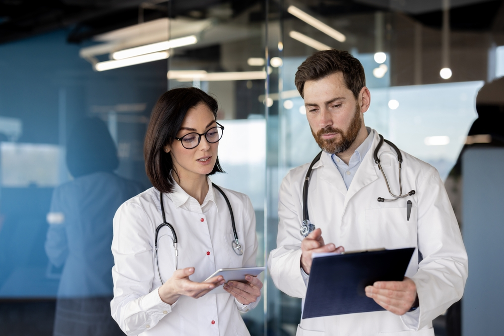 Clinicians collaborating with a tablet
