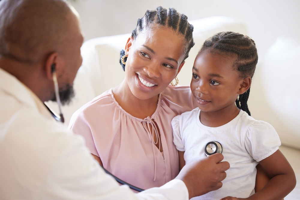 Parent and child smiling during a checkup