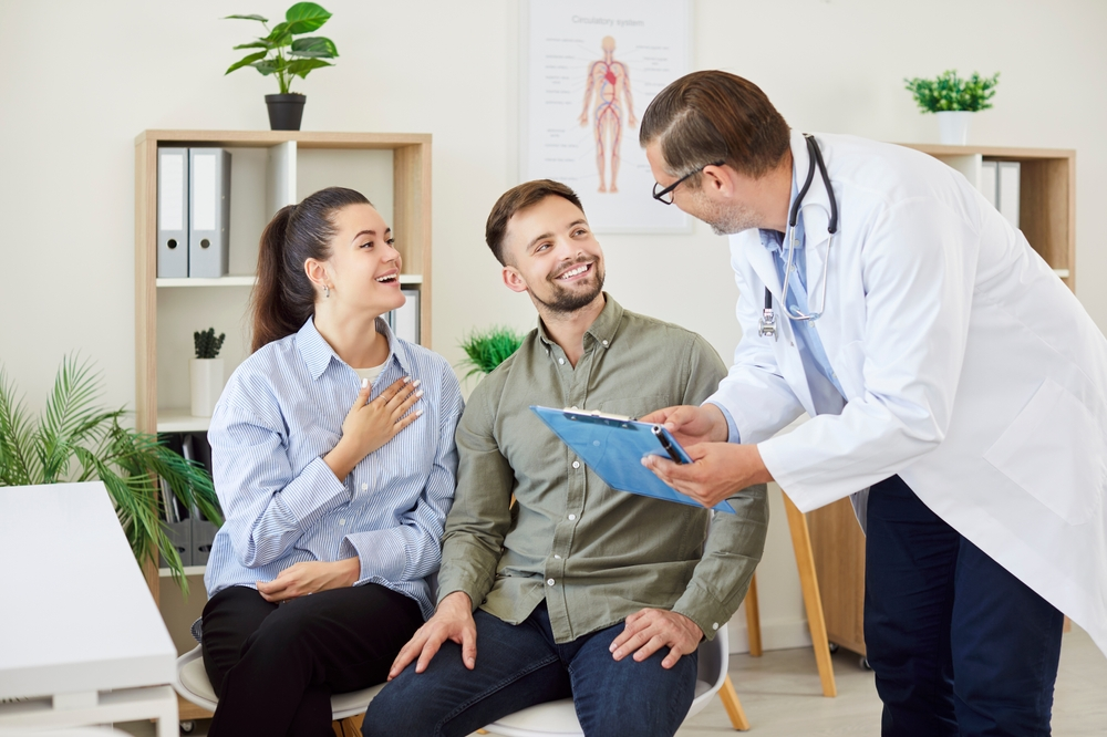 Clinician greeting a couple during a consultation in a modern clinic