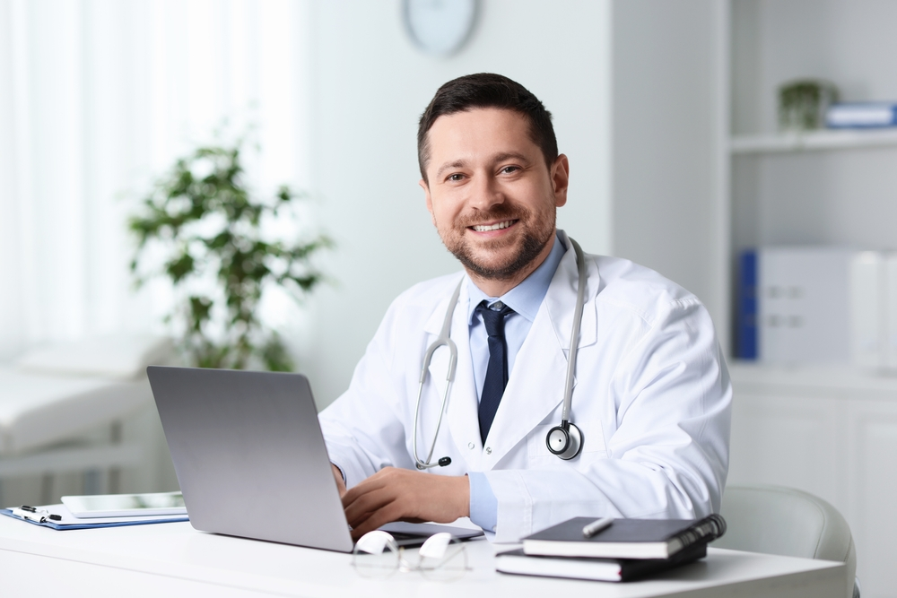 Smiling doctor at desk